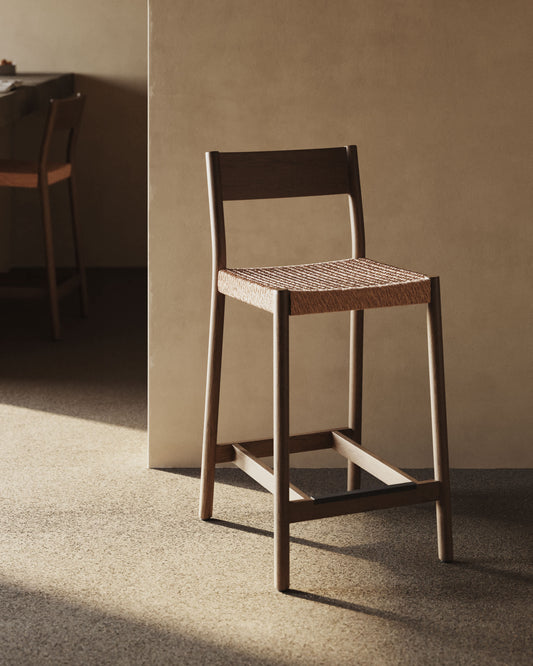 Sgabello Yalia con schienale in legno massello di rovere con finitura in noce e seduta in corda da 65 cm