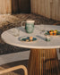 Tavolo rotondo da esterni Alcaufar in legno massiccio di teak e cemento grigio Ø 120 cm