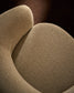 Poltrona girevole Odenia in micro bouclé beige