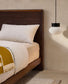 Testiera Norlen in impiallacciatura di noce con finitura scura e luce LED per letto fino a 180 cm